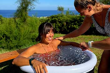 Focused women in a guided ice bath during a yoga retreat in Menorca